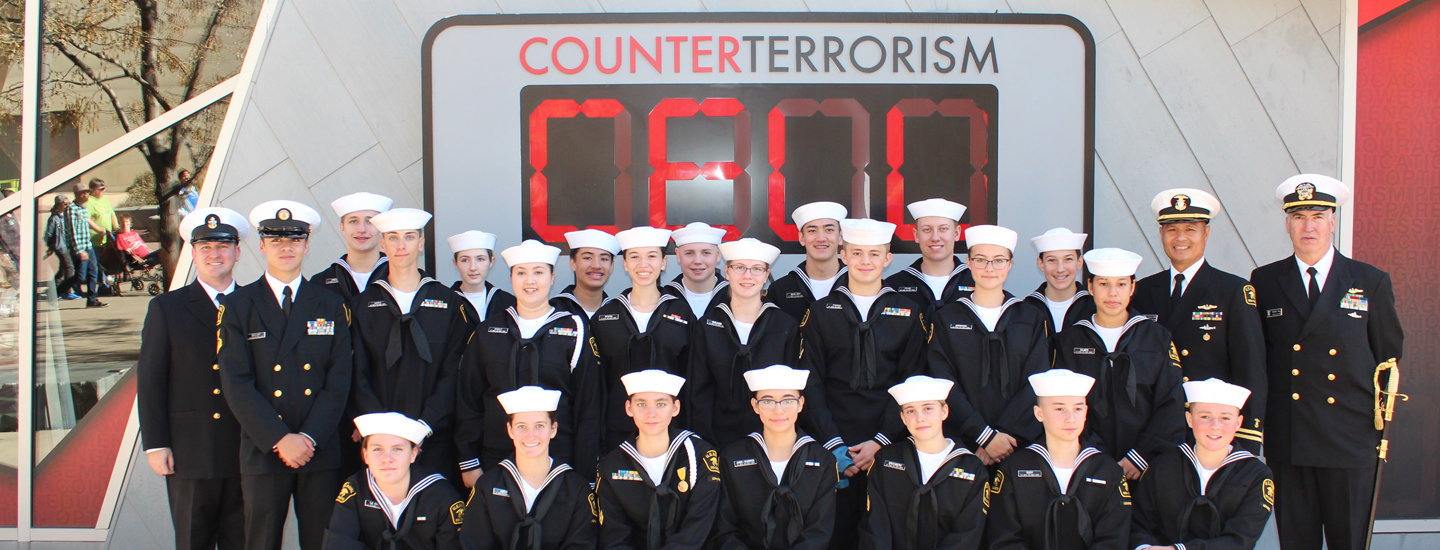 Navy personnel in uniform standing outside the CELL exhibit