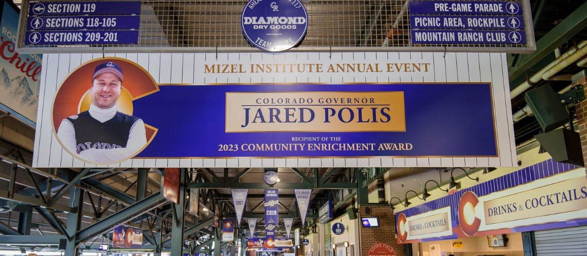 Sign recognizing Governor Jared Polis of receiving the 2023 Mizel Institute Community Enrichment Award